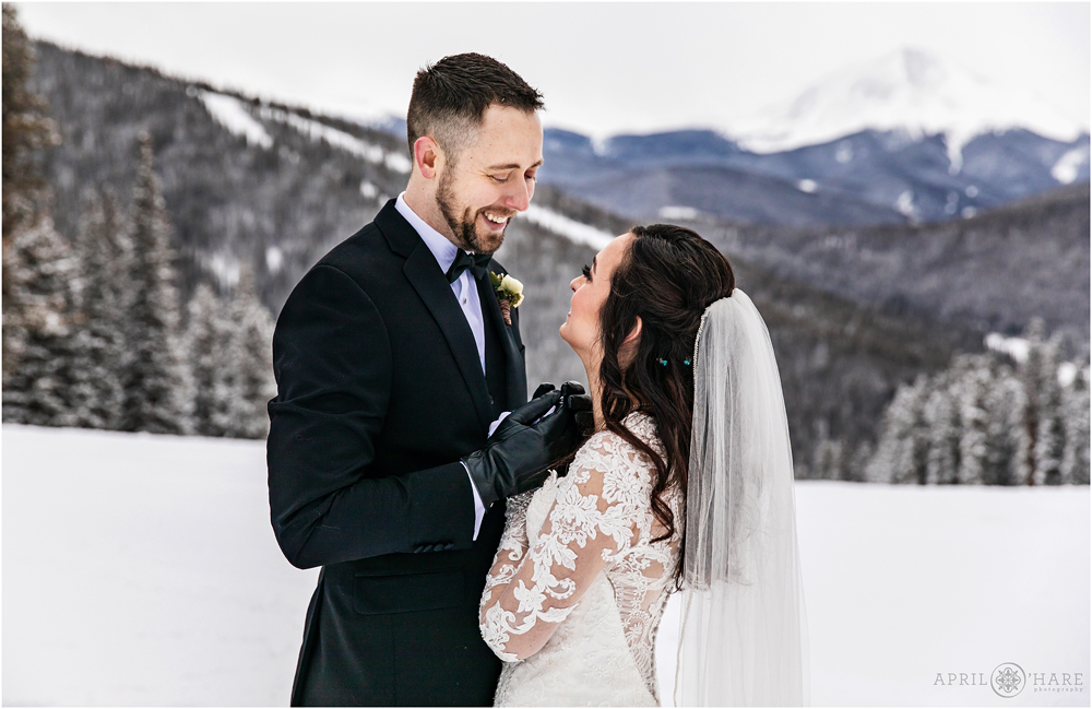 Bride and groom have a sweet moment during their romantic photo time at Keystone Resort during winter