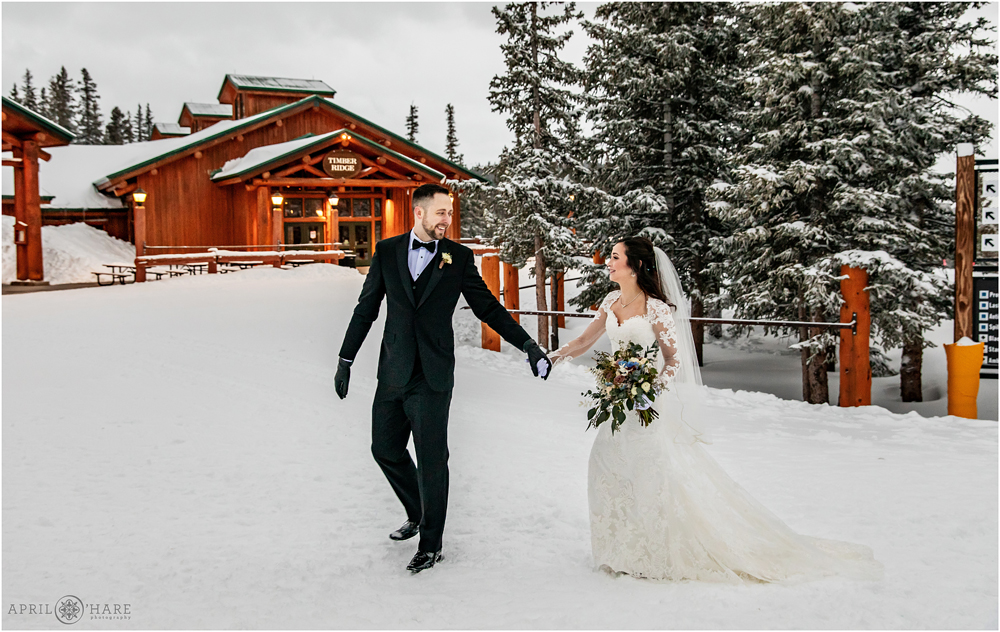 Groom leads his bride back to the reception at Alpenglow Stube in Keystone Colorado