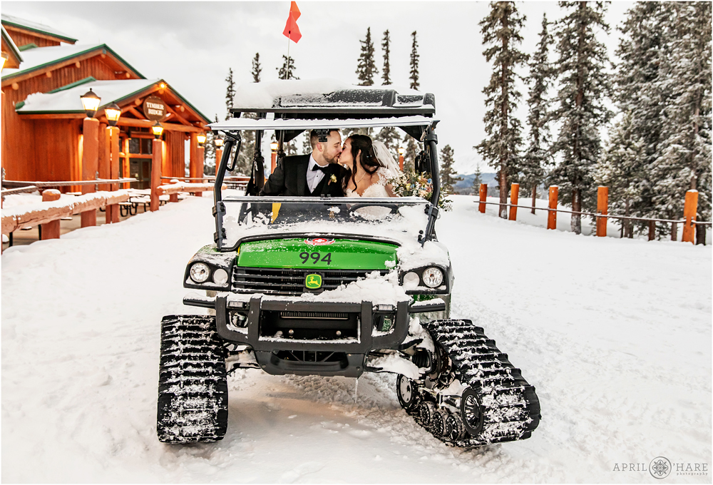 Cute photo of bride and groom on a medic snowmobile at Keystone Resort in CO