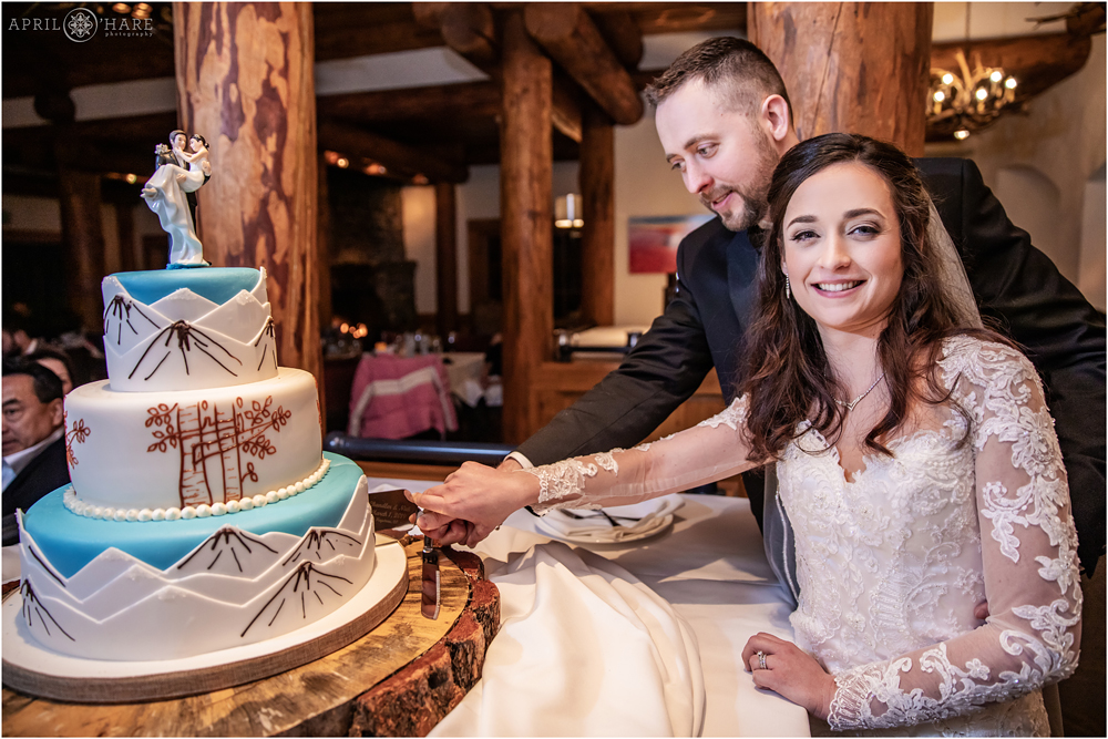 Bride and groom cut their cake at Alpenglow Stube Keystone Colorado