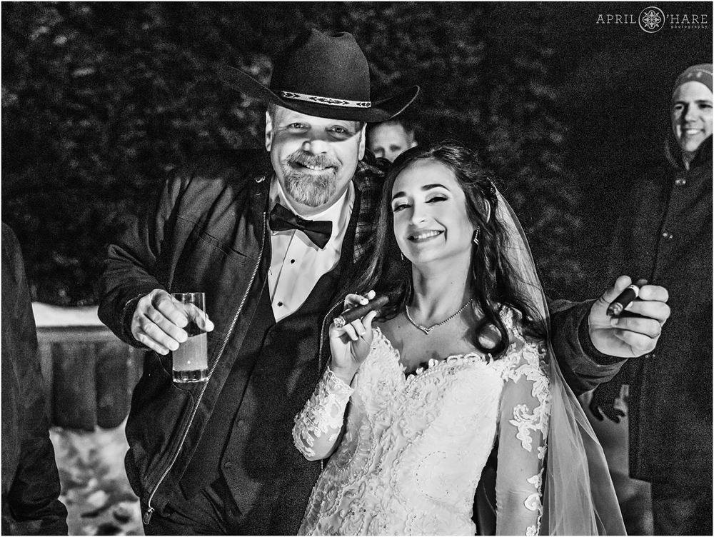 Dad and his daughter smoke cigars on her wedding day at Alpenglow Stube in Keystone