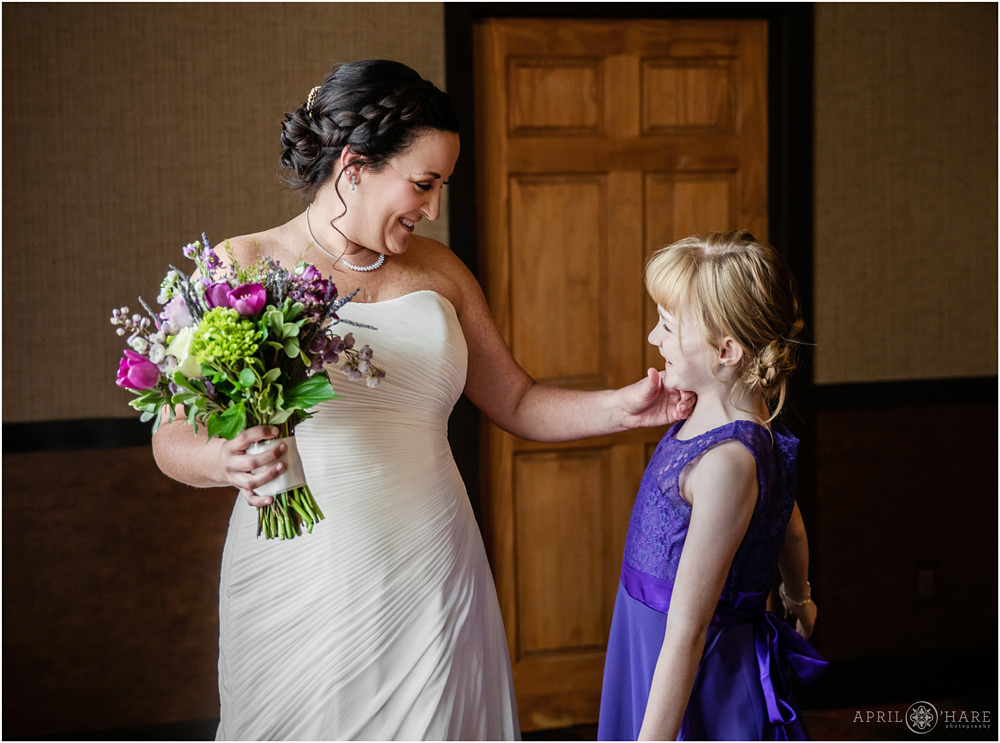 Bride smiles at her daughter at her Golden Hotel Wedding