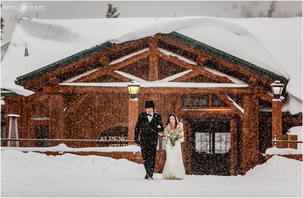 Bride and her father walk from Alpenglow Stube to Anticipation Run at outdoor snowy winter wedding in Colorado