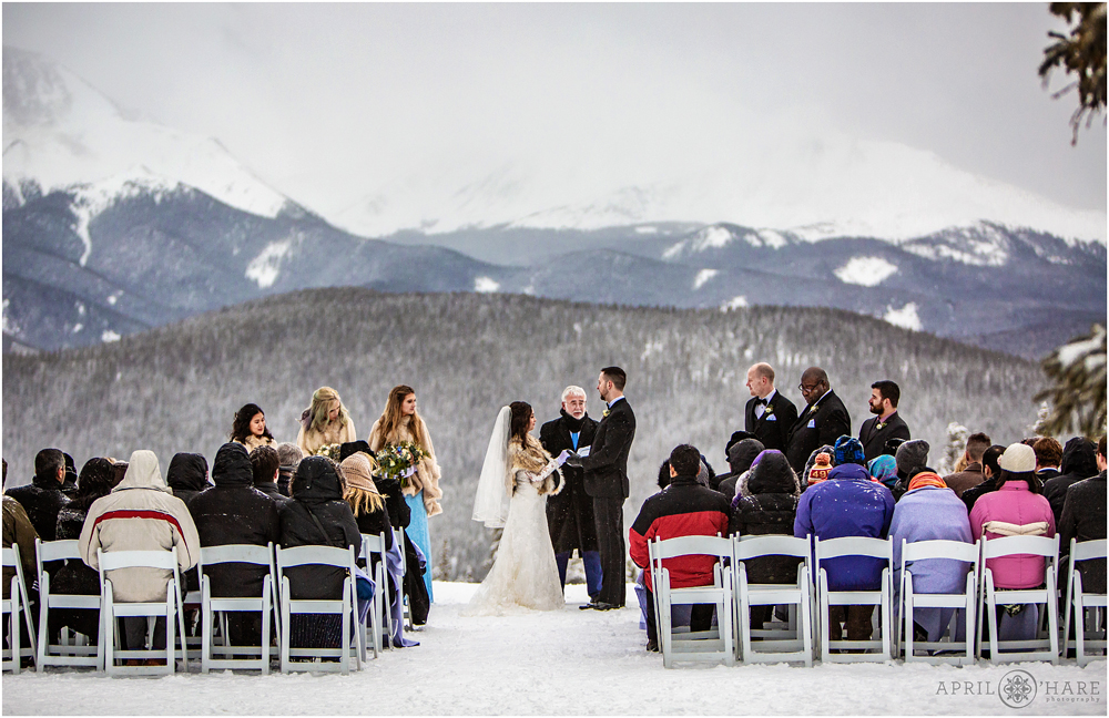 Gorgeous outdoor wedding ceremony during winter with mountain views at Keystone Resort in Colorado