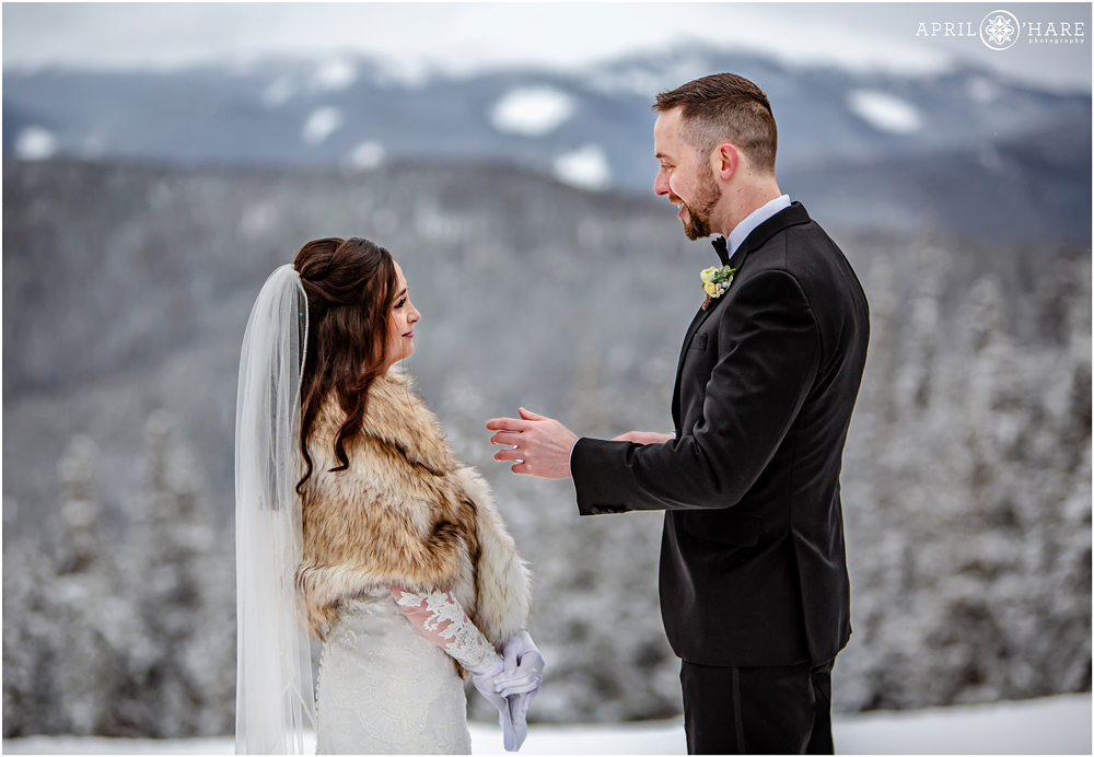 Bride and groom say their vows with tears in their eyes at Keystone Resort in CO