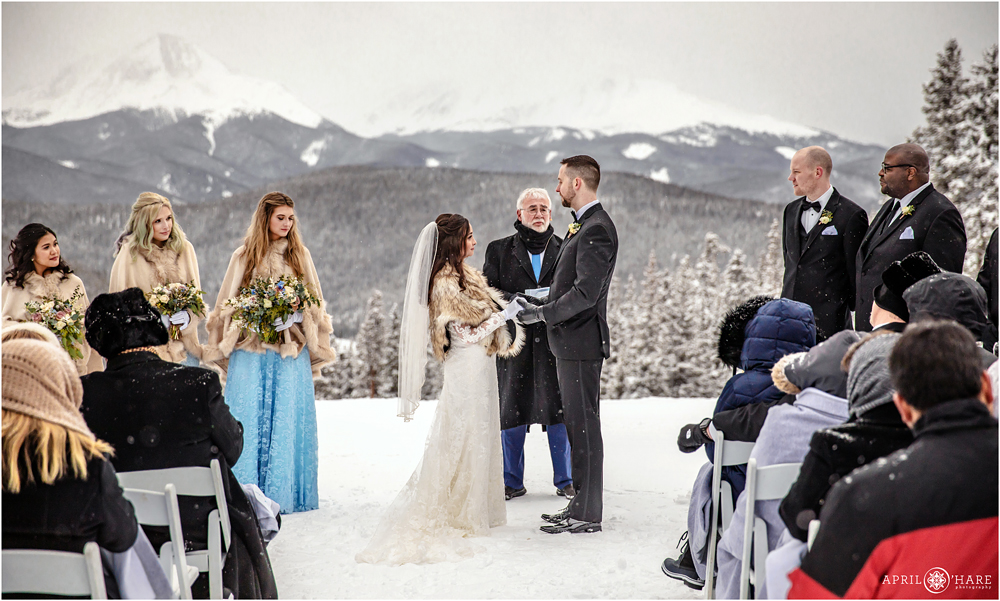 Outdoor winter wedding ceremony at Anticipation ski run at Keystone