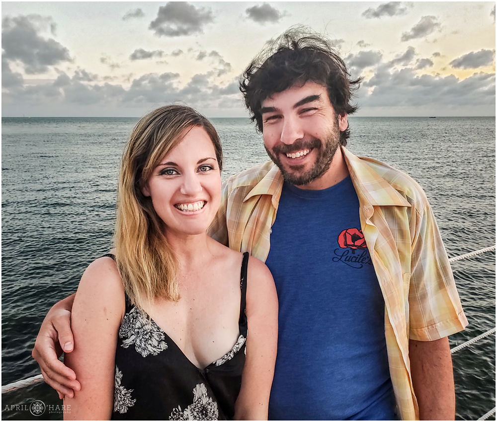 Cute couple posing for a photo on the pier at Sunset Grille and Raw Bar in Marathon Florida