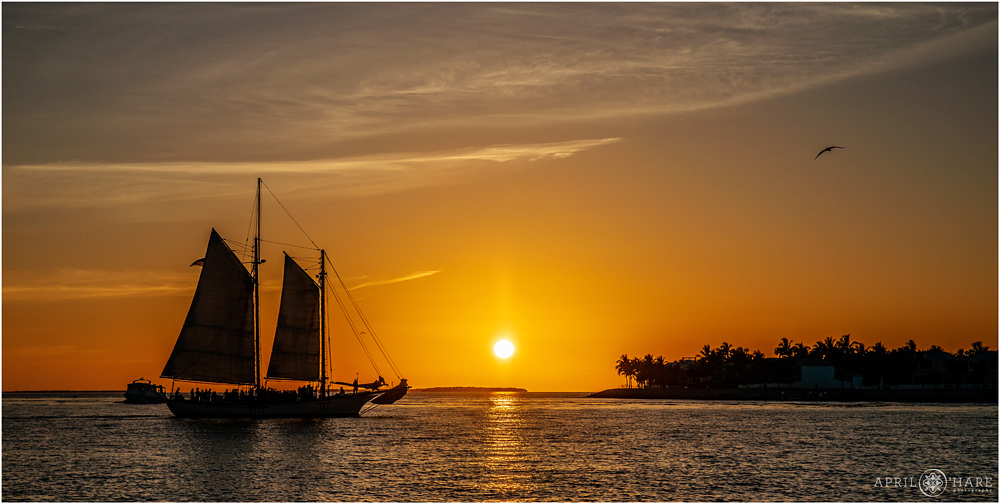 Stunning Orange sunset with old schooner ship in the foreground at Mallory Square in Key West