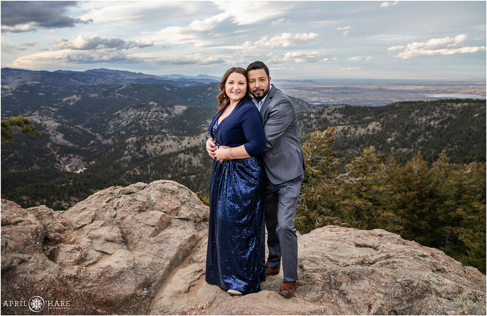 A beautiful couple laughs together as they get anniversary portraits created on a windy chilly spring day at Lost Gulch Overlook in Boulder Colorado