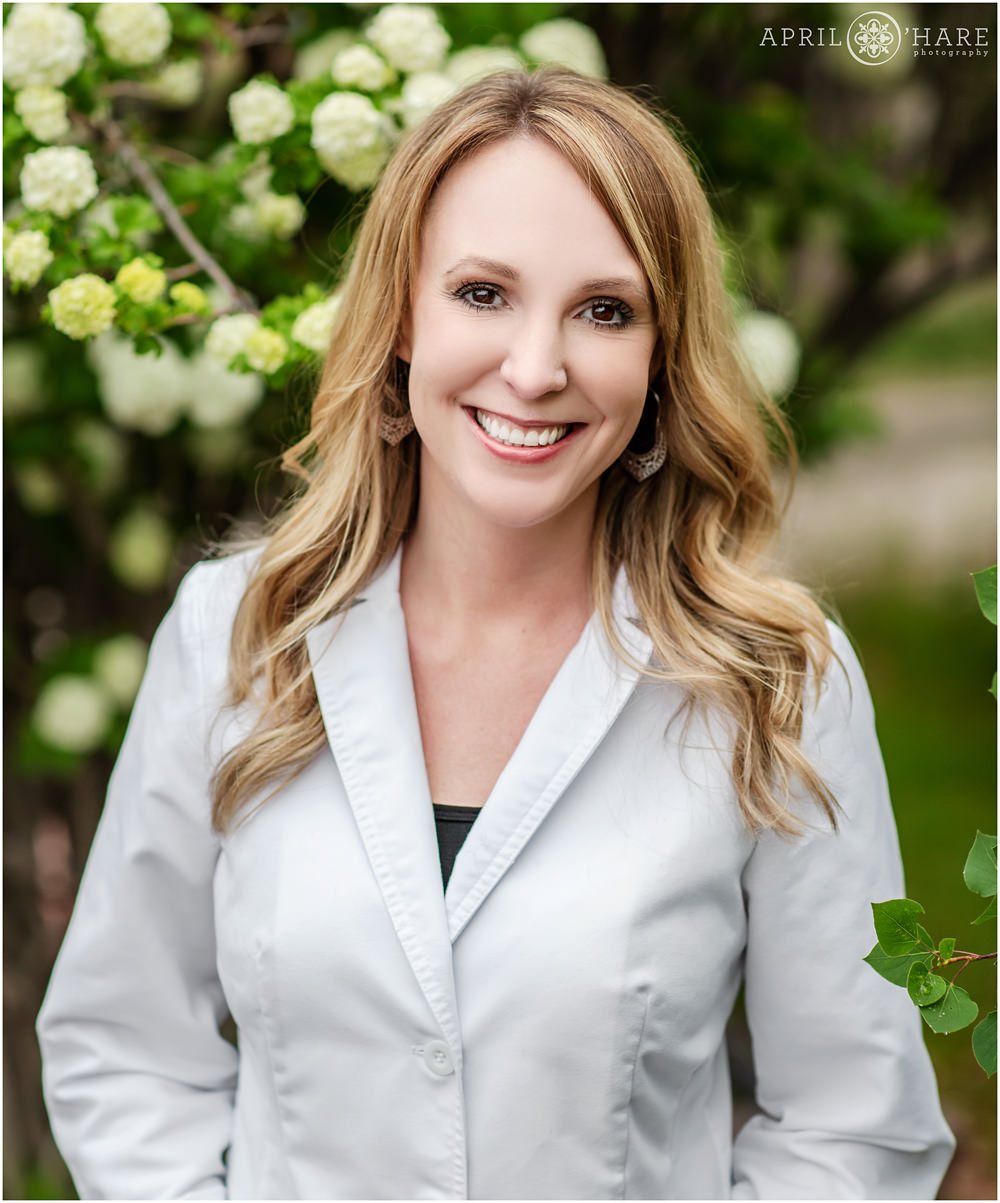 Outdoor business portrait of woman in lab coat during Spring in Colorado