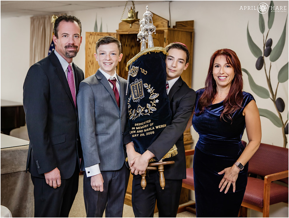 Jewish family poses for a formal portrait with the Torah at B'Nai Chaim Bar Mitzvah