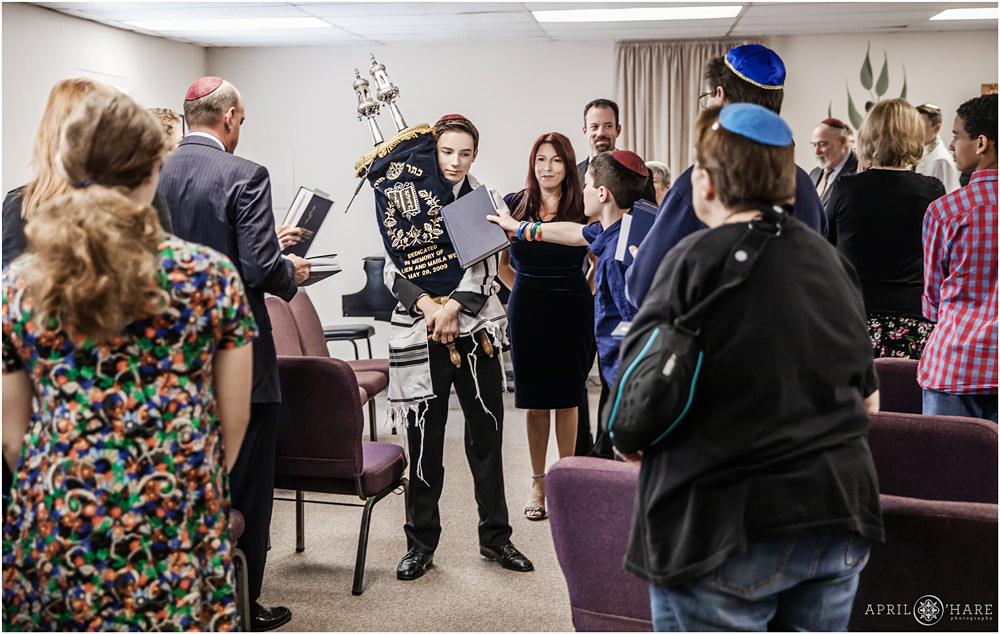 Carrying Torah for Congregants to Touch their Prayer Books on it