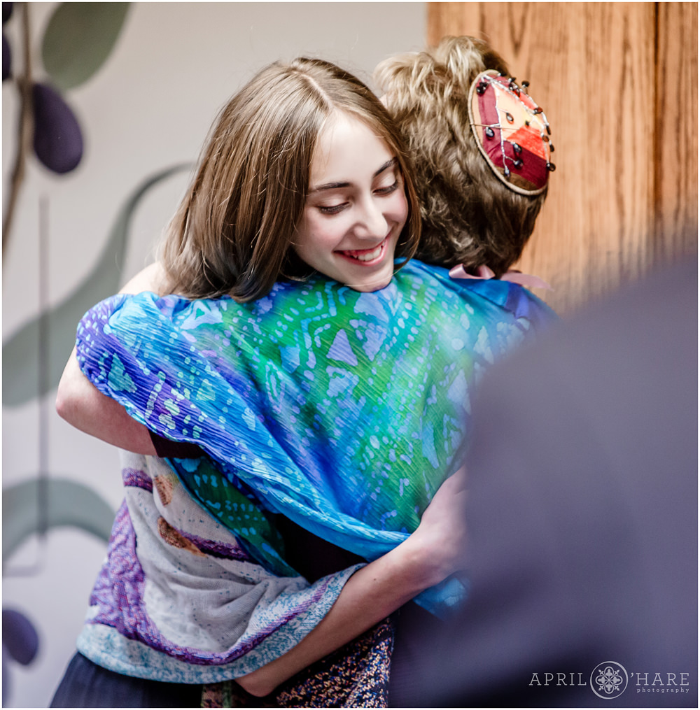 Girl hugs her rabbi at her bat mitzvah celebration in Denver