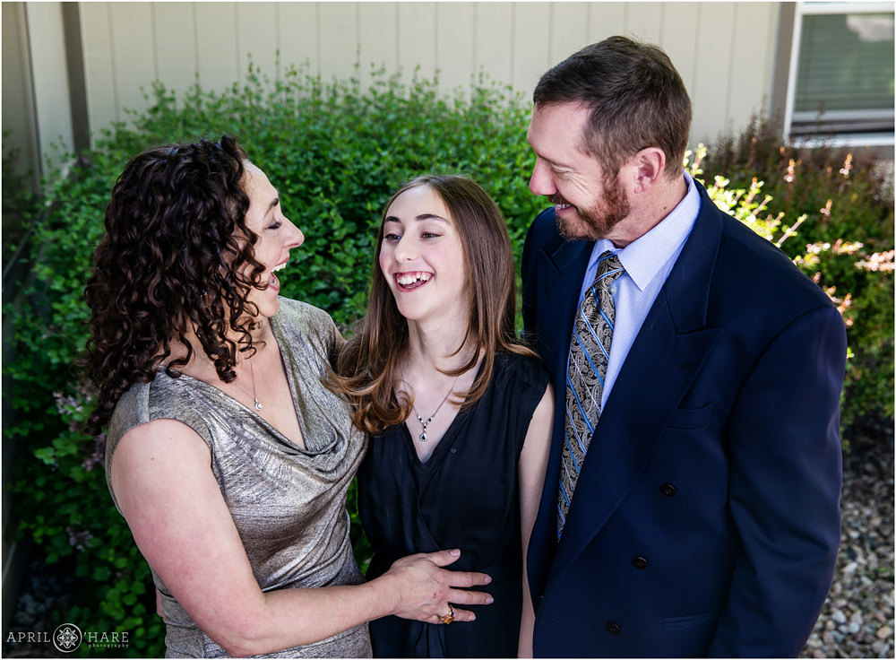 Bat Mitzvah Girl laughs with her mom and dad prior to service at Temple in Denver