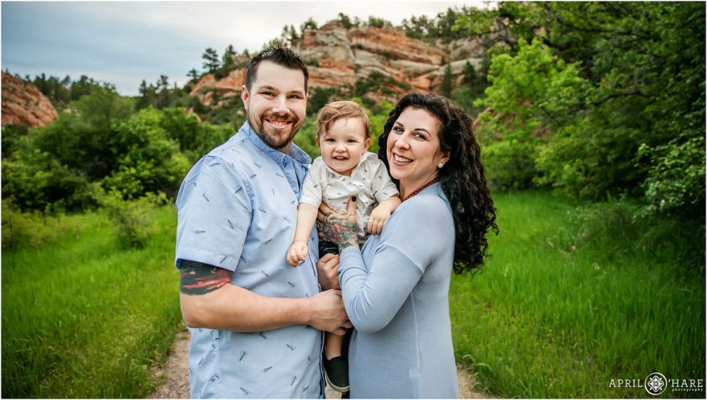 Sweet Smiling Baby with his Parents during family photos at Roxborough State Park