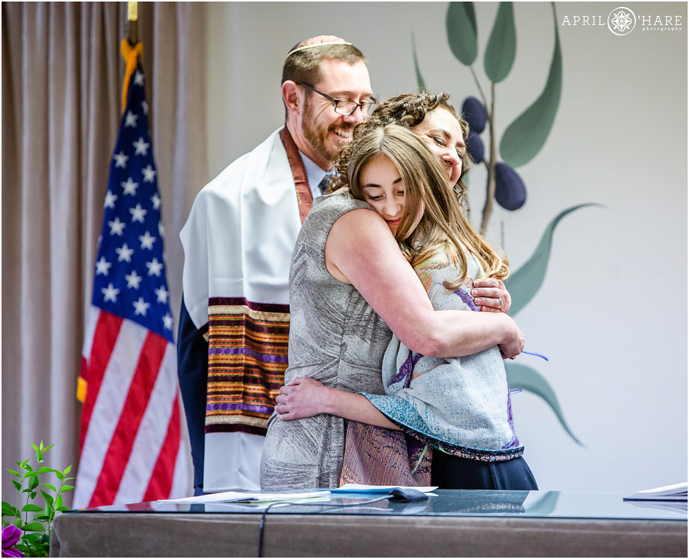 Mom hugs her daughter during bat mitzvah service in Denver