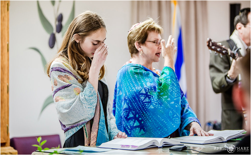 Covering eyes during prayer at Jewish Bat Mitzvah Celebration in Colorado