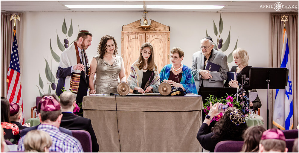 Family stands with their daughter as she reads from the Torah at B'Nai Chaim Bat Mitzvah