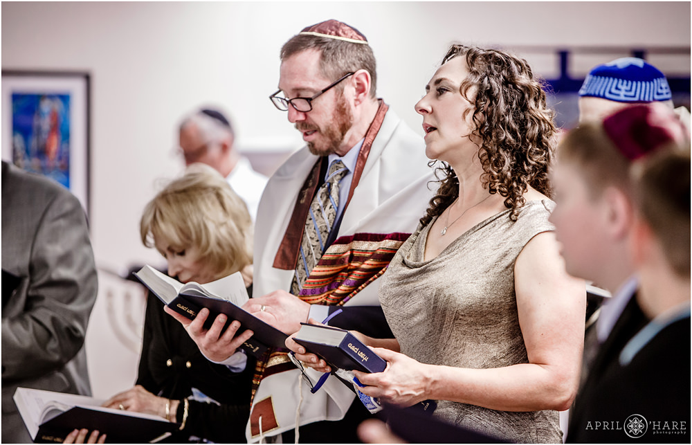 Parents of bat mitzvah girl sing during jewish service in Denver