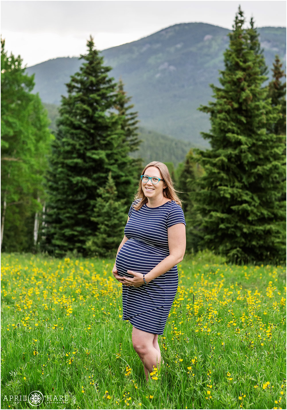 Unique Mountain Maternity Portraits in a field of yellow wildflowers