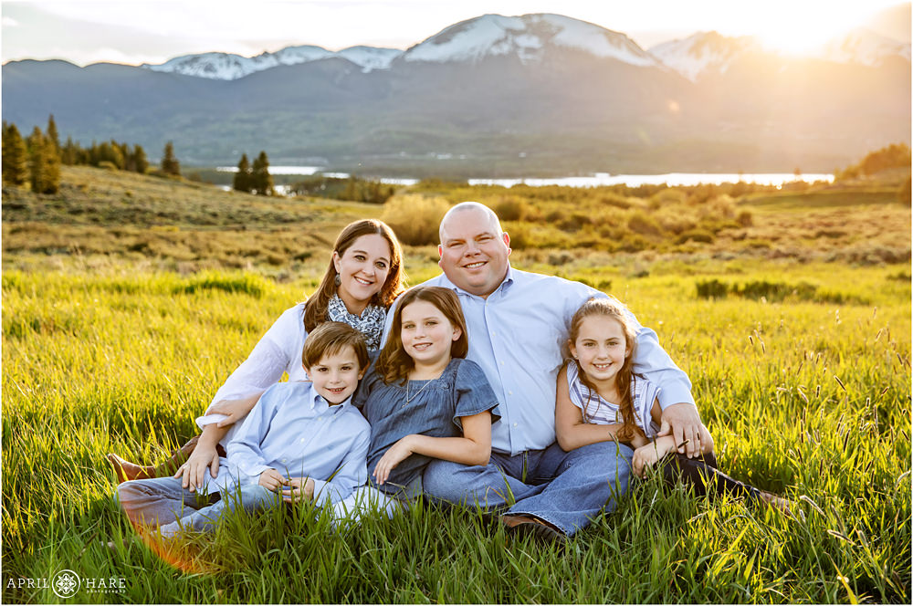 Summit County Family Photography sitting in the grass at sunset nearLake Dillon
