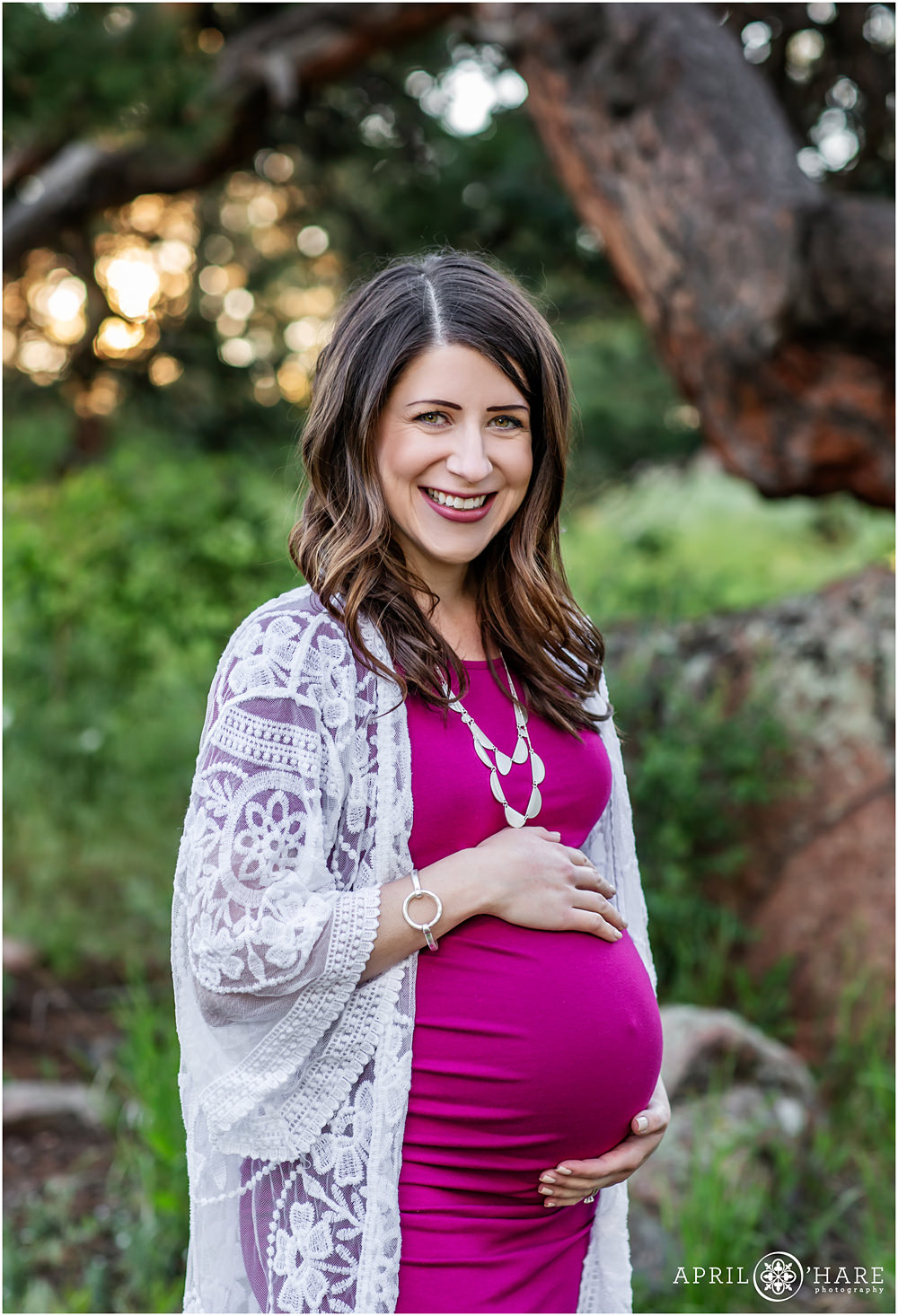 Beautiful Maternity Portrait of a Mom to Be in a Pretty Fuschia Dress at Mount Falcon in Evergreen