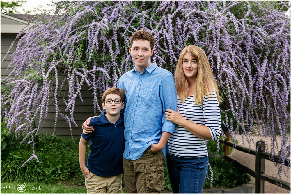 Littleton Family Photographer with beautiful flowering purple tree in the background at Hudson Gardens