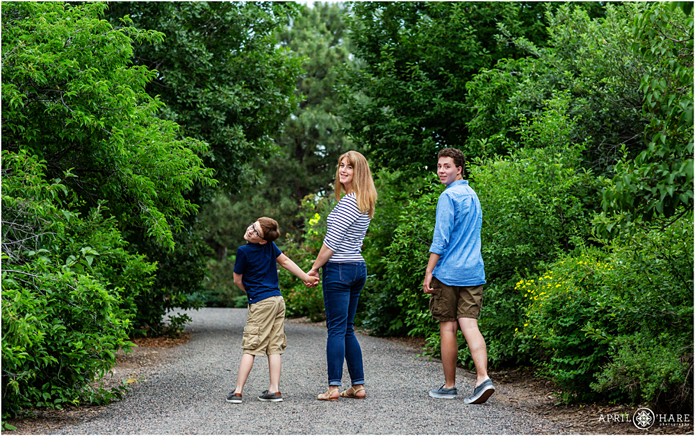 Fun Littleton Family Photographer along a pretty tree-lined path at Hudson Gardens