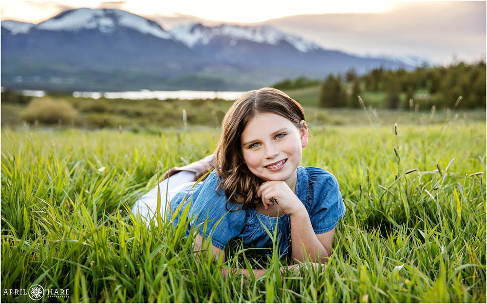 Summit County Family Photography at sunset in the tall green grass at Lake Dillon