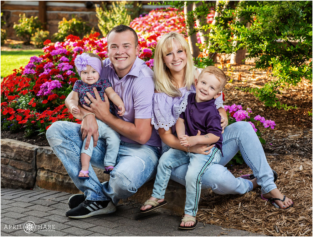 Cute family wearing purple and lilac pose for pictures at their Littleton Extended Family Photo session at Hudson Gardens