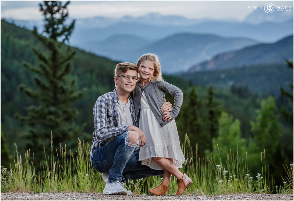 Sibling portrait with mountain view during an extended family photography session in Evergreen