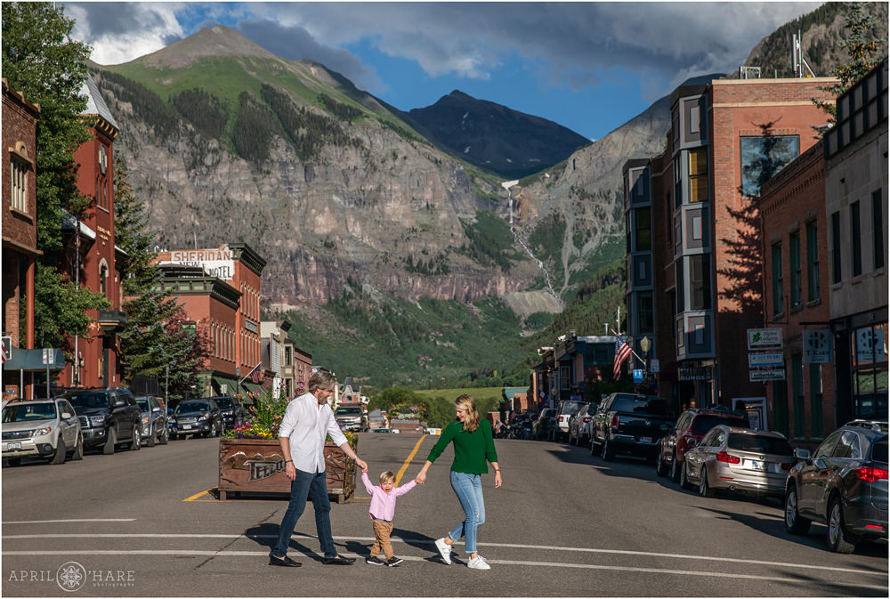 Cute family walks across the street in Telluride Colorado
