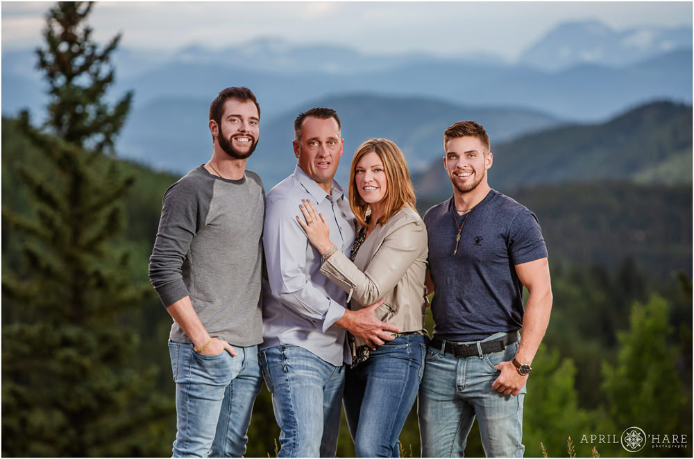 Family with adult sons pose for a portrait with a Denver extended family photographer in Colorado
