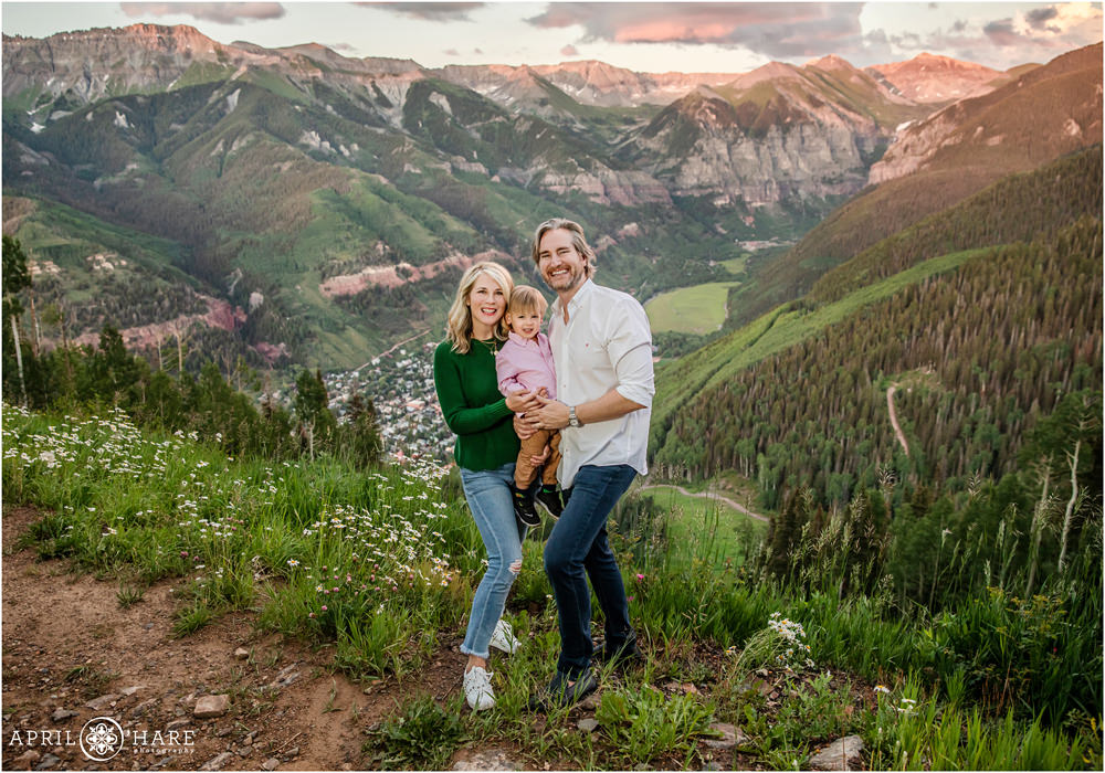 Telluride Family Photographer captures a family with a young son at Sunset with mountain views at San Sophia Overlook