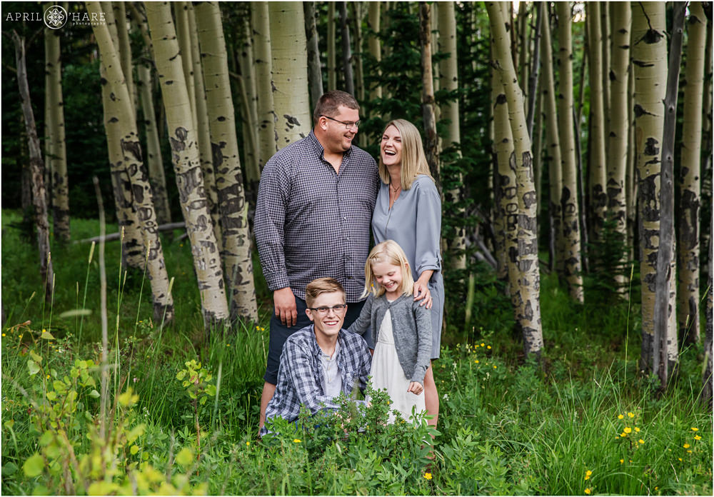 A family laughs together during their extended family photography session in Evergreen CO