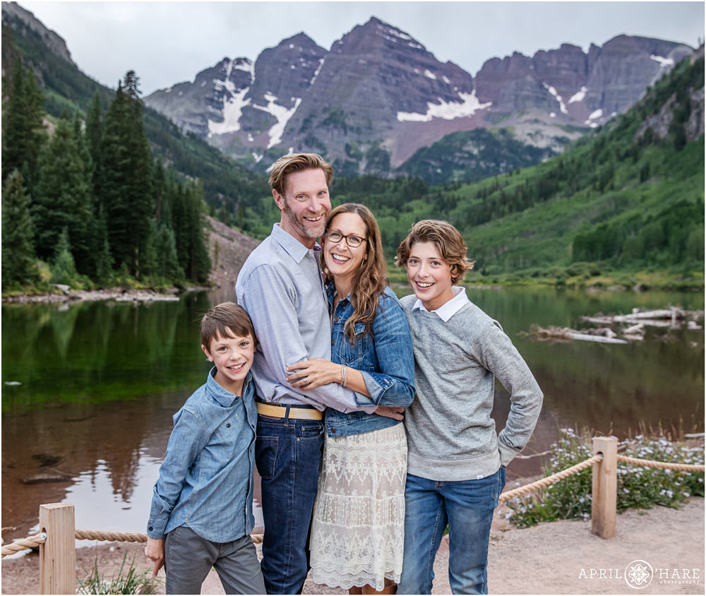 Family of four photographed in front of Maroon Lake at Maroon Bells in Aspen Colorado