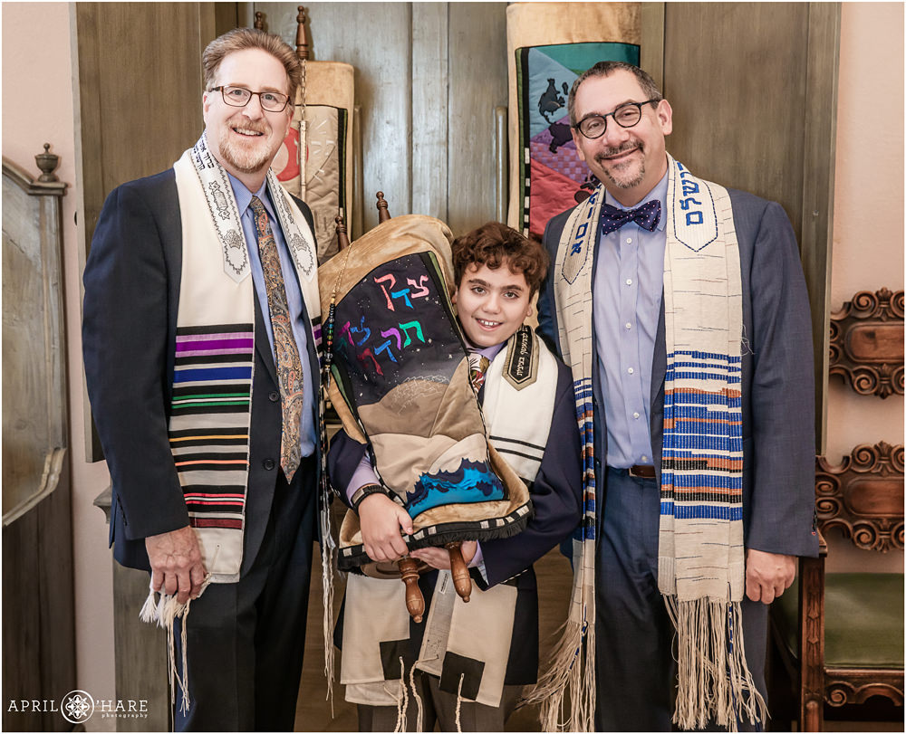 Rabbi, Cantor and Bar mitzvah boy pose for a formal portrait with the Torah at Temple Emanuel in Denver CO