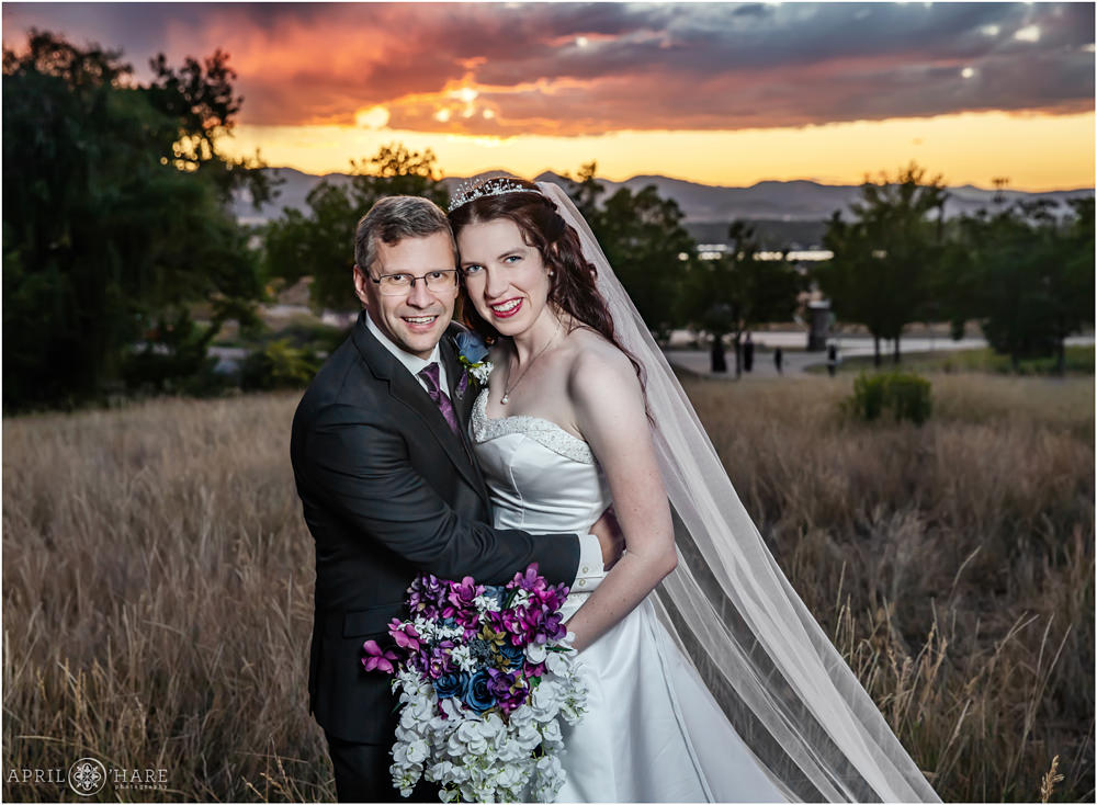 Classic portrait of a wedding couple posing in front of a pretty mountain sunset at Flyin' B Park