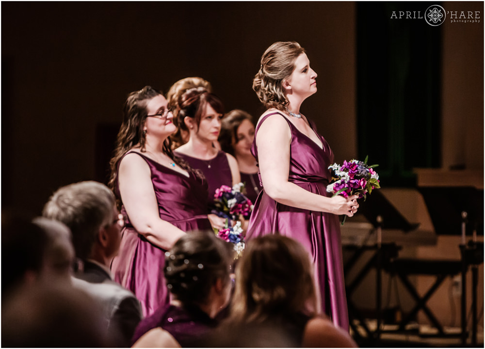 Bridesmaids wearing long purple dresses at a wedding at Our Father Lutheran Church in Colorado