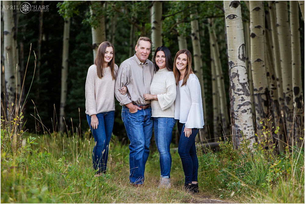 A classic beautiful family portrait in an aspen tree grove near Denver Colorado