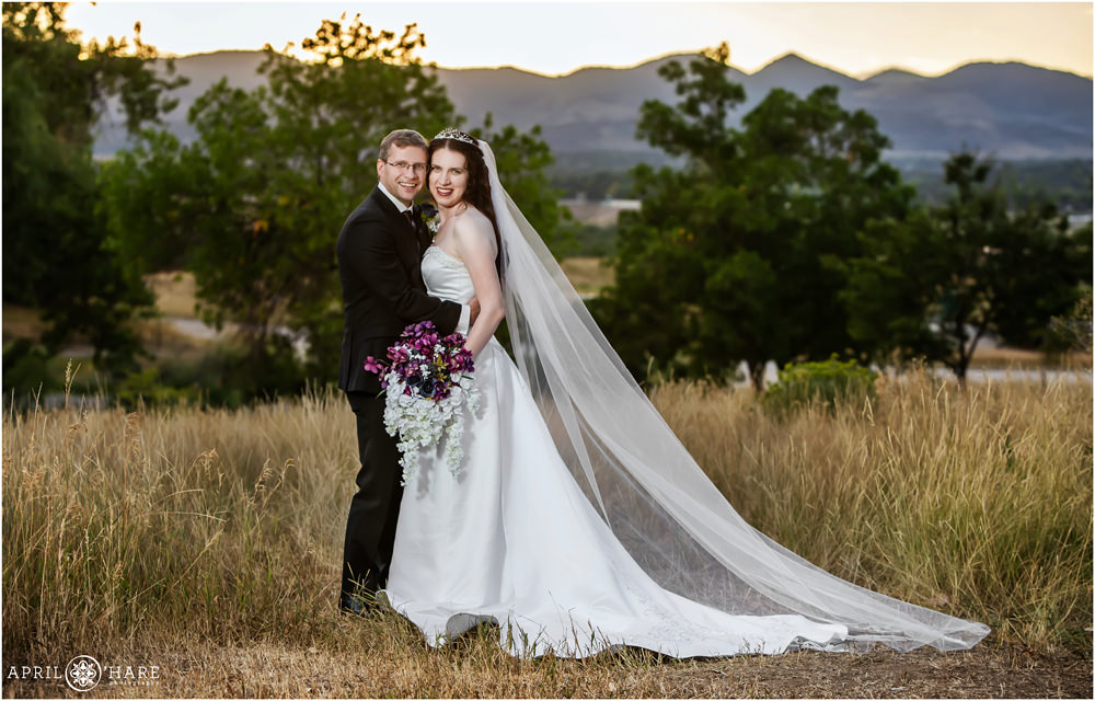 Classic Bride and Groom photography with pretty mountain backdrop at Flyin' B Park in Highlands Ranch Colorado