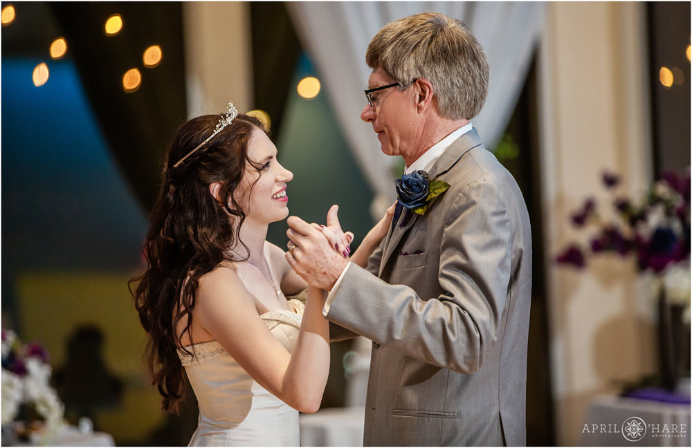 Bride wearing a tiara smiles at her dad during father daughter dance at Ashley Ridge Wedding Reception