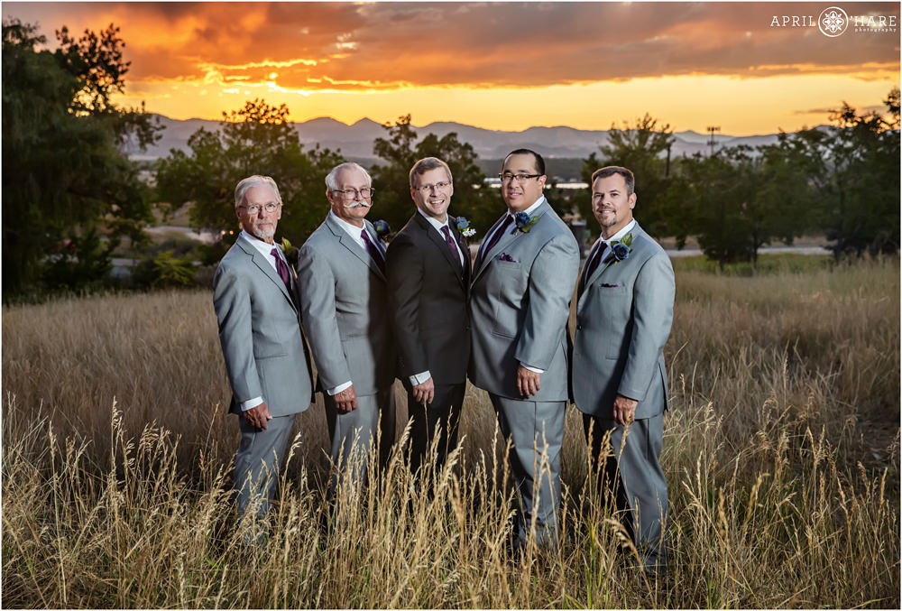 Groom with his groomsmen portrait at sunset with mountain view at Flyin' B Park in Highlands Ranch