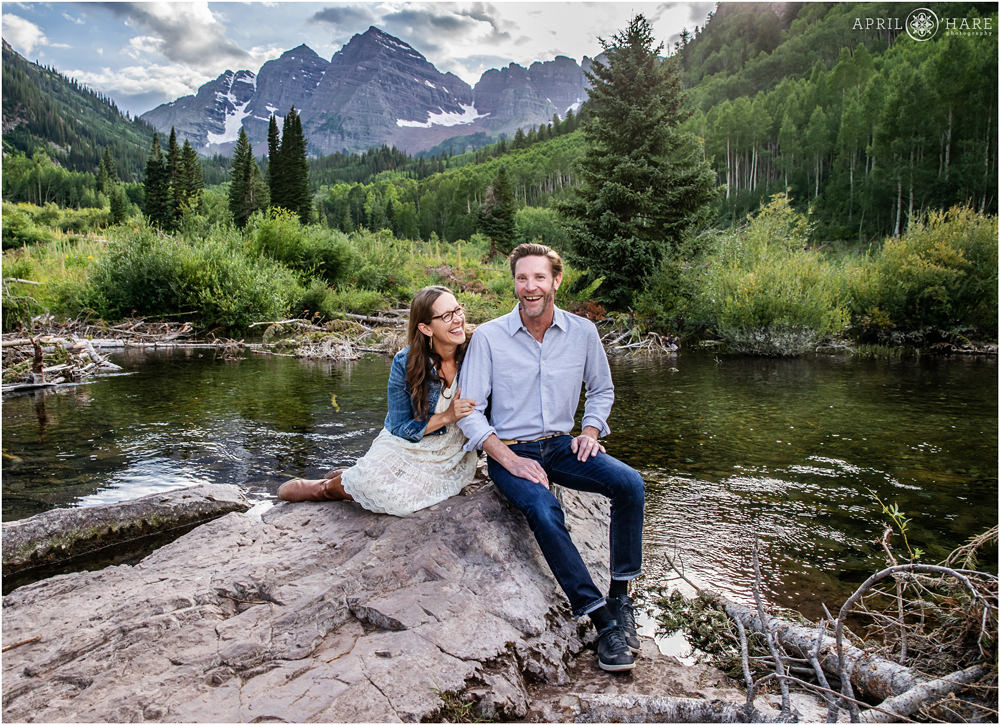 Husband and wife laugh together during their family photography session at Maroon Bells in Aspen Colorado