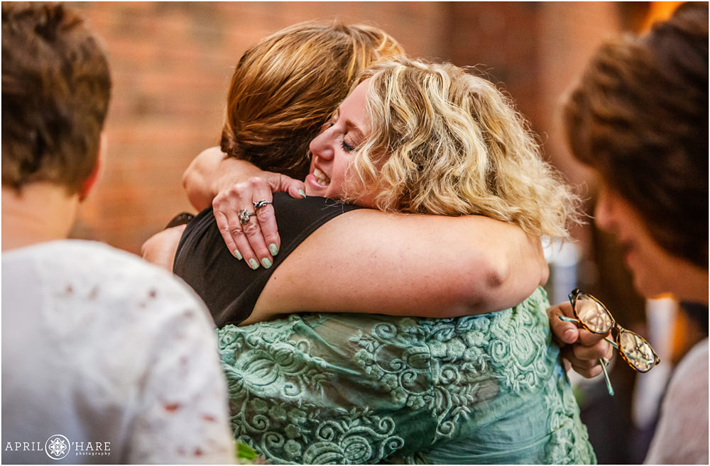 Mom hugs a friend at her son's bar mitzvah at Temple Emanuel in Denver