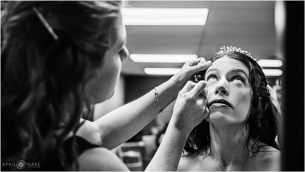B&W Photo of Bridesmaid helping bride with her makeup at Our Father Lutheran Church