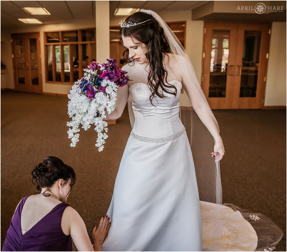 Bride gets help with her dress at Our Father Lutheran Church in Centennial Colorado