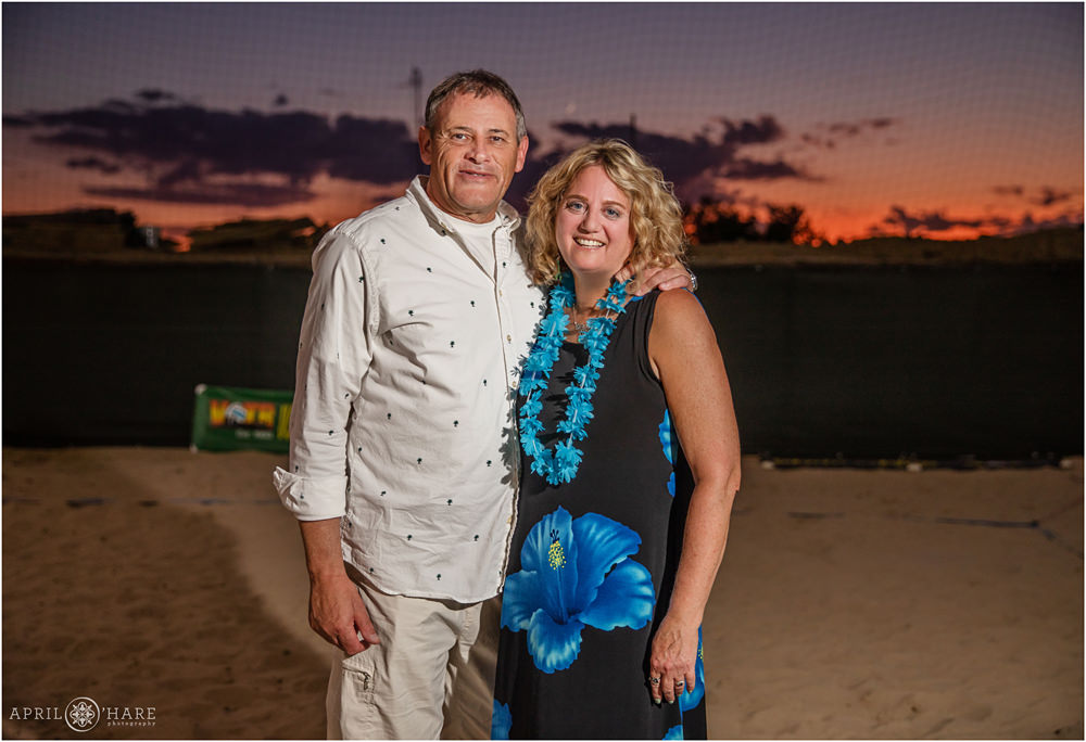 A couple poses for a sunset portrait at an island themed bar mitzvah party at The Island Event Center in Aurora CO
