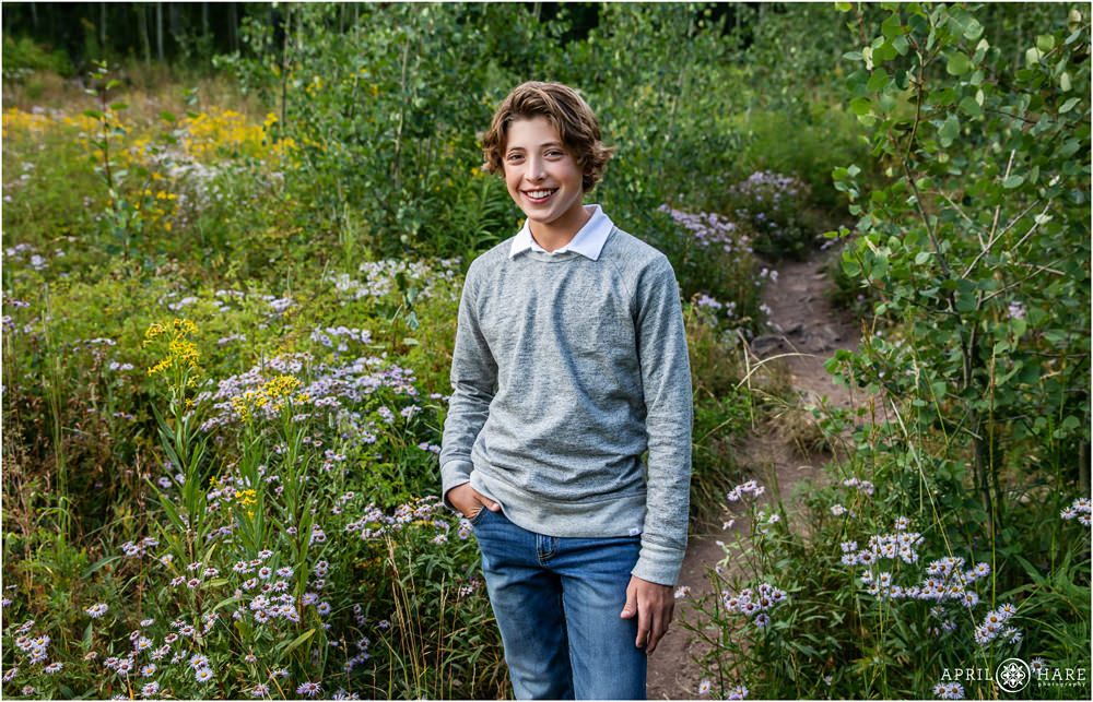 Young man poses for a portrait during his family's professional photography session at Maroon Bells