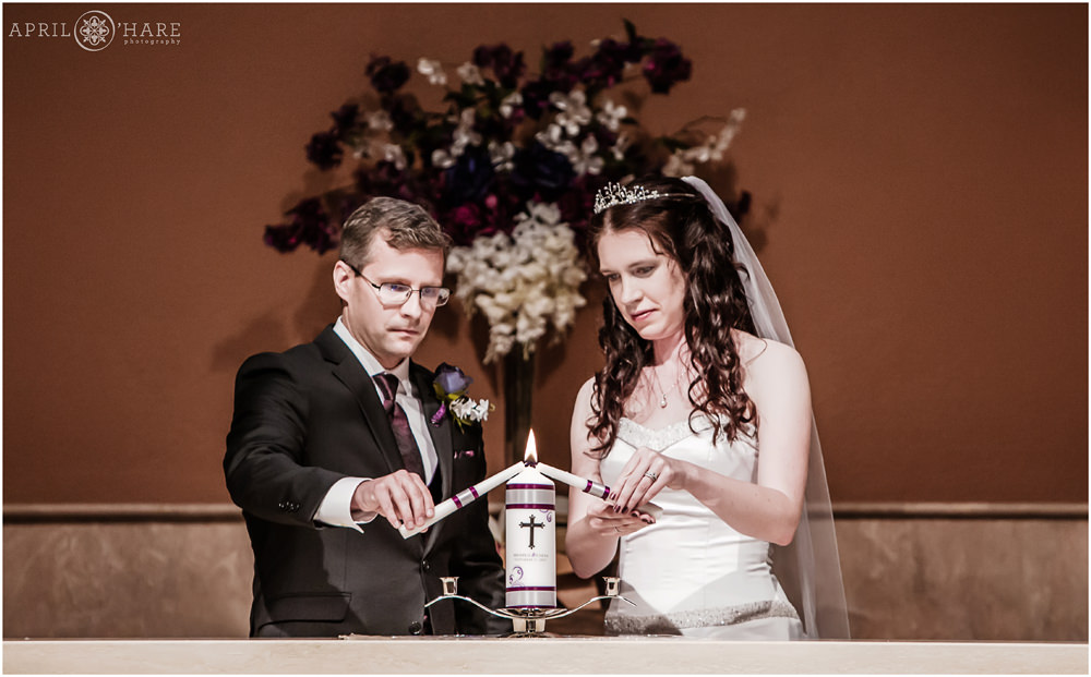 Bride and groom light a unity candle at Our Father Lutheran Church in Centennial Colorado